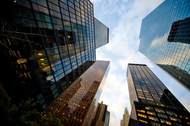 financial buildings pointing towards the sky on a sunny day